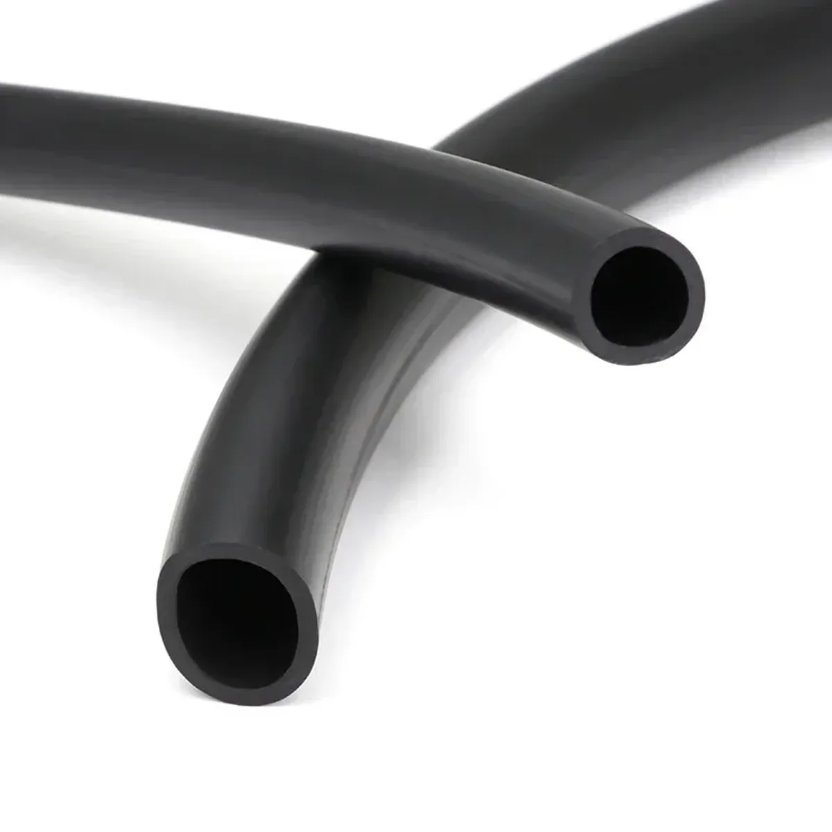 Washing machine hose: gloved hand holding black tubing loops.