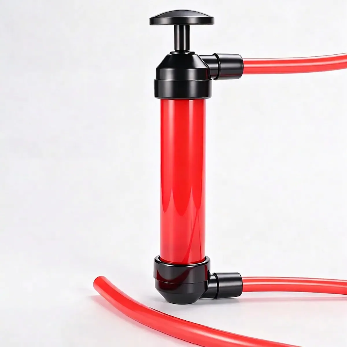 Manual red and black plastic siphon pump with two flexible red transfer hoses attached.