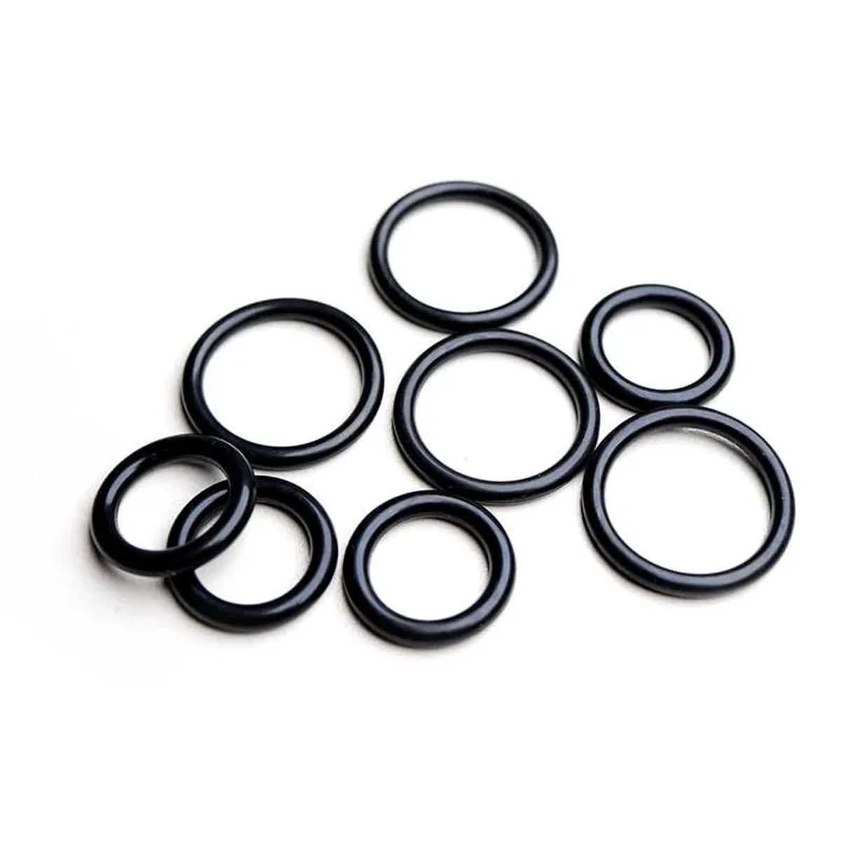 Set of black rubber O-rings in several sizes laid out together