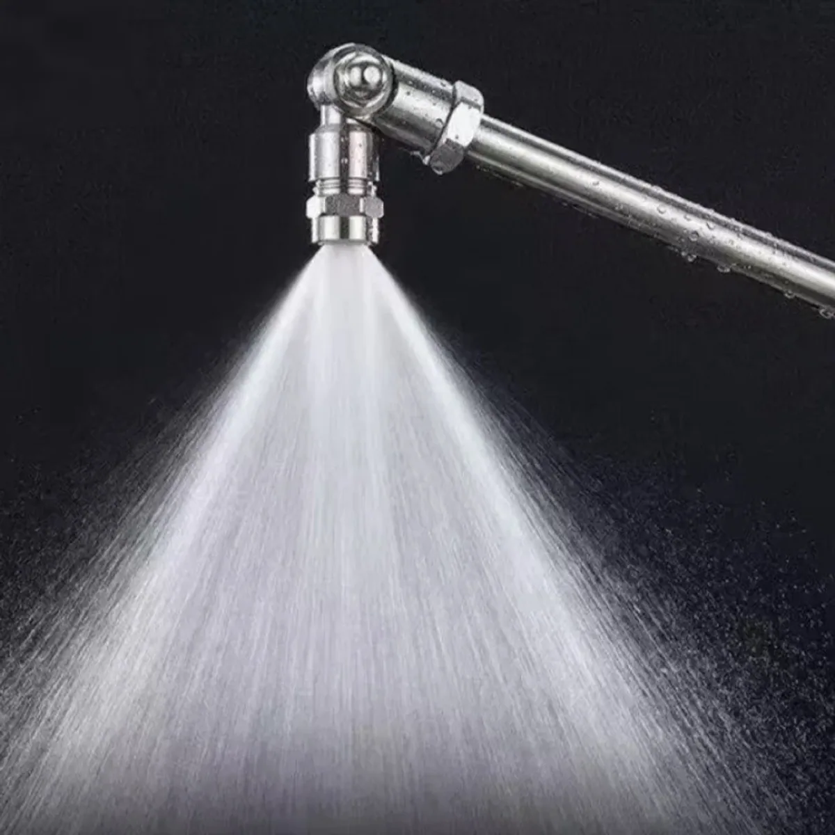 Stainless steel rotating spray nozzle with a jet of water spraying from the tip
