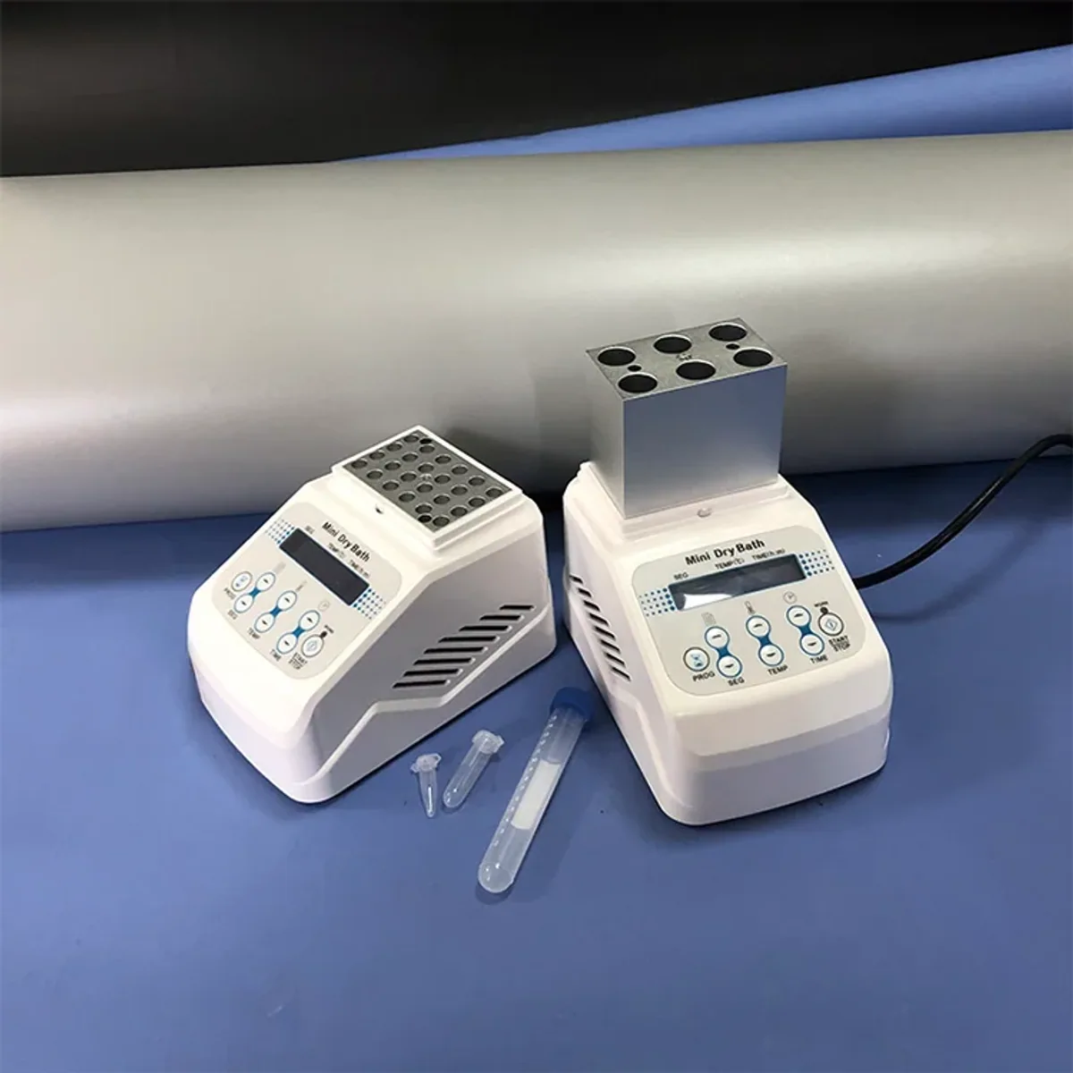 Two mini dry bath units with transparent covers holding sample tubes in aluminium heating blocks