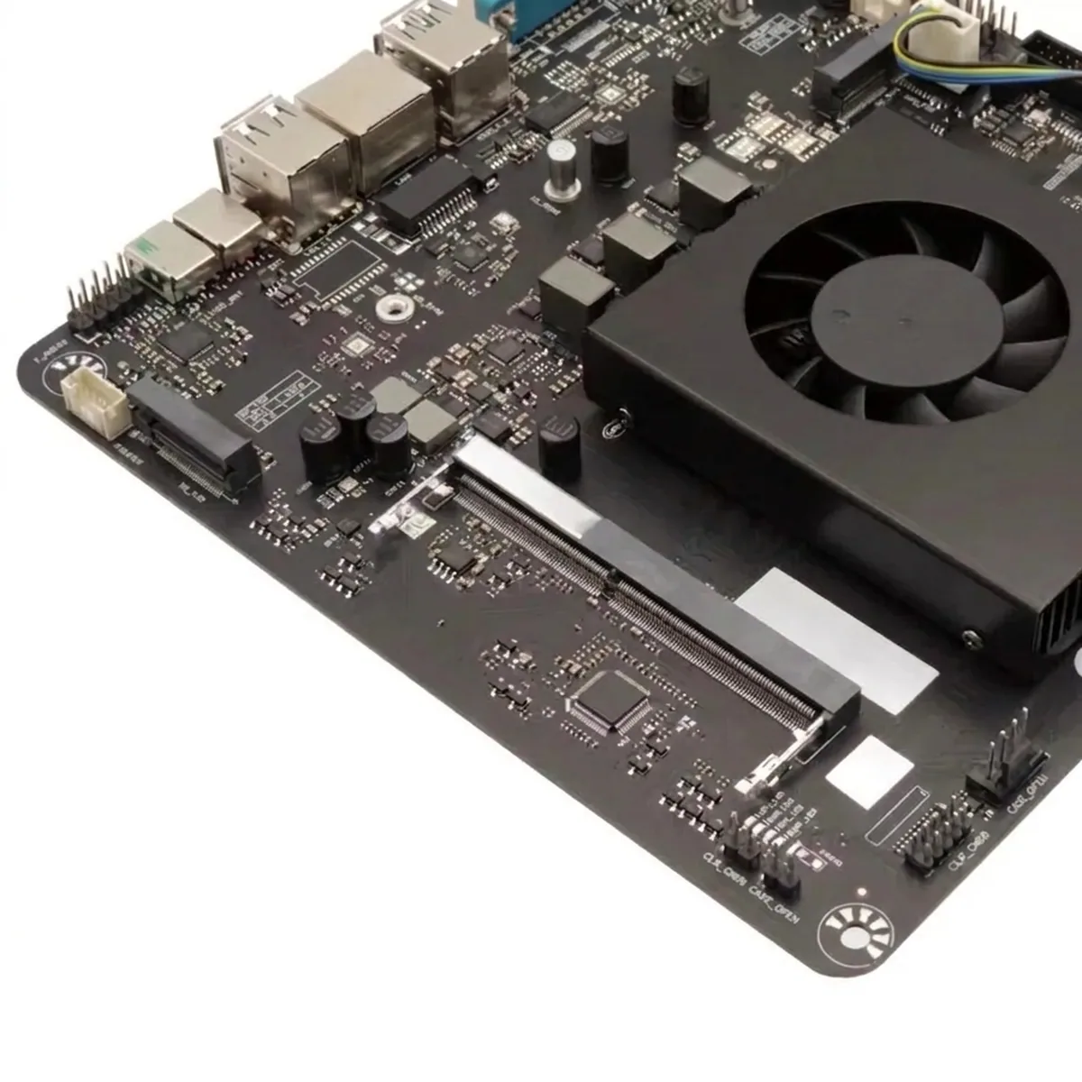 Industrial Mini PC motherboard featuring integrated cooling fan, memory slot, and rear I/O ports.